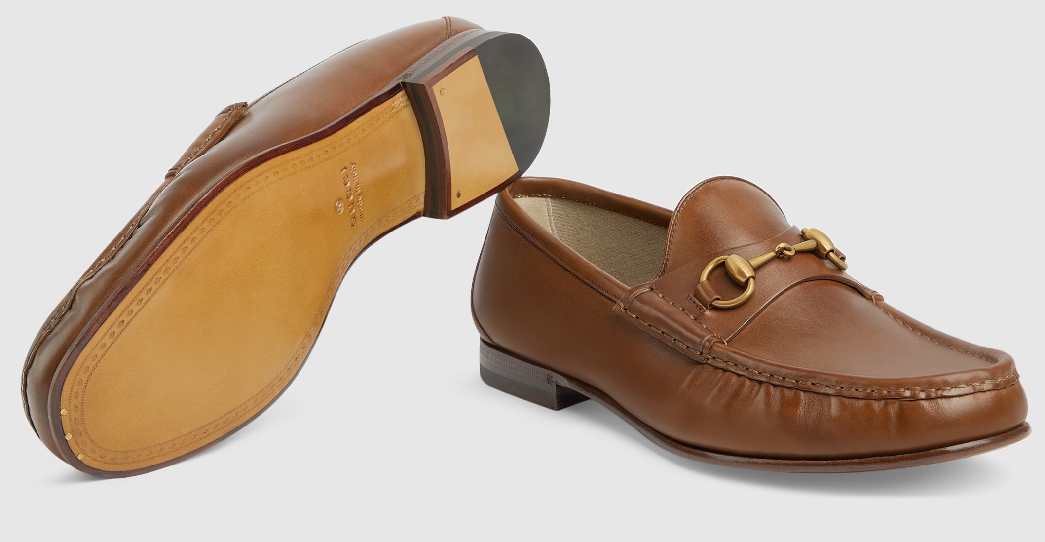 Gucci brown leather horsebit loafers with gold hardware.